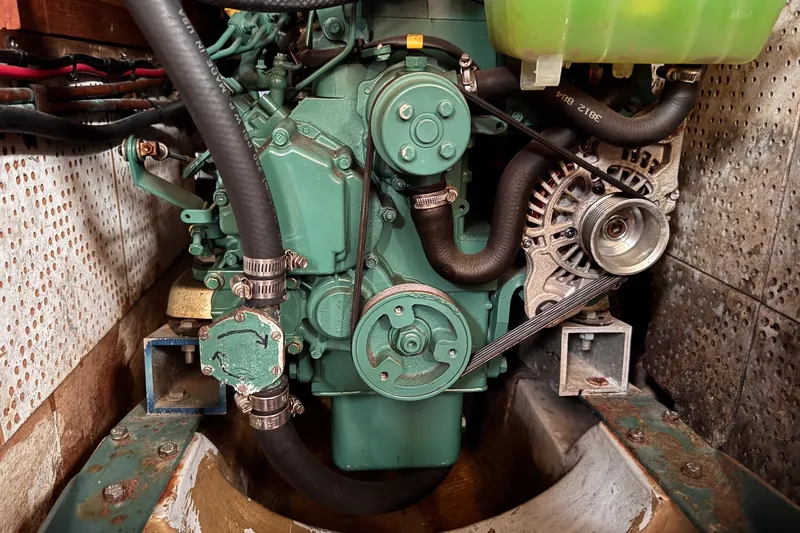 Slide: The Image of Engine compartment of a 1979 C&L Marine 36 boat, showcasing mechanical components and hoses. - 44