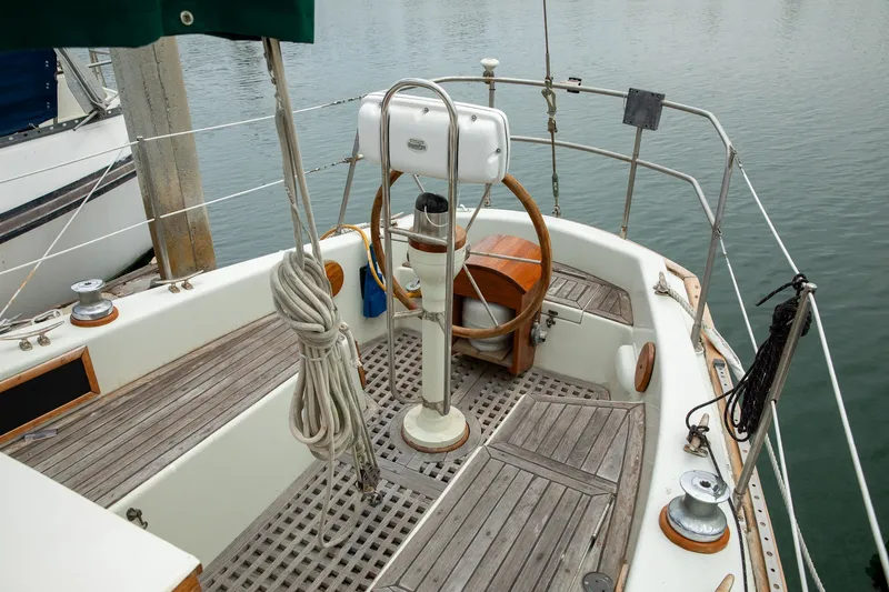 Slide: The Image of 1979 C&L Marine 36 sailboat cockpit with wooden wheel and deck, docked at marina. - 12