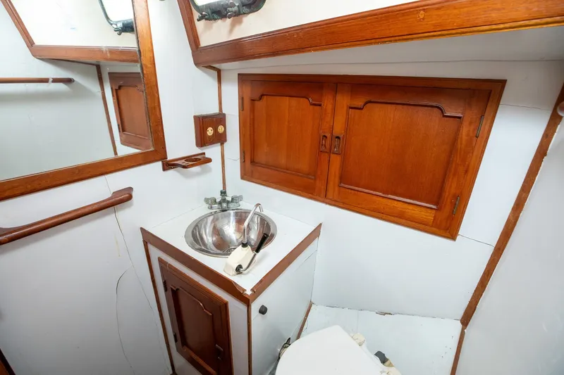 Slide: The Image of 1979 C&L Marine 36 yacht bathroom with wooden cabinets and stainless steel sink. - 41