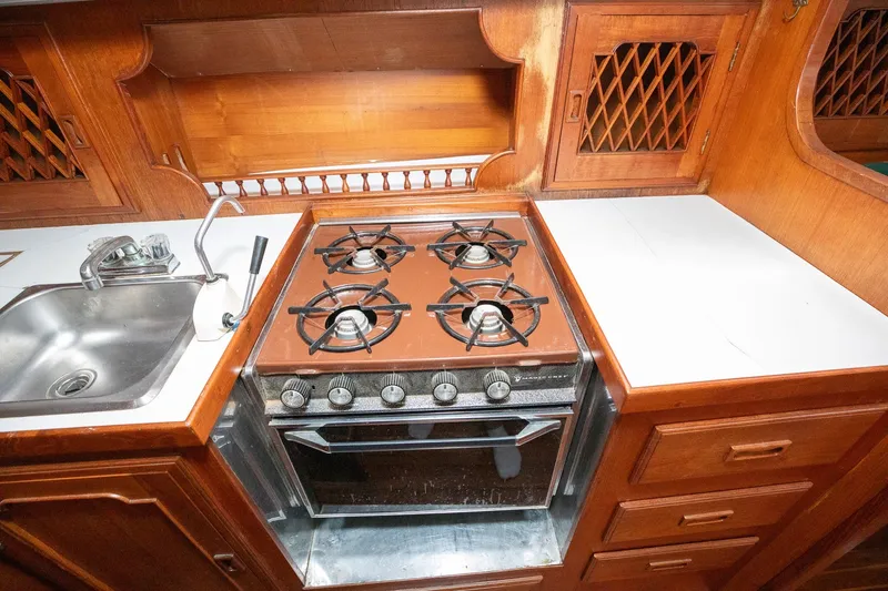 Slide: The Image of Vintage 1979 C&L Marine 36 yacht kitchen with stove, sink, and wooden cabinetry. - 29