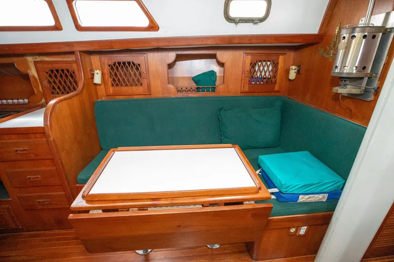 Slide: The Image of Cozy 1979 C&L Marine 36 yacht interior with green cushions and wooden cabinetry. - 24