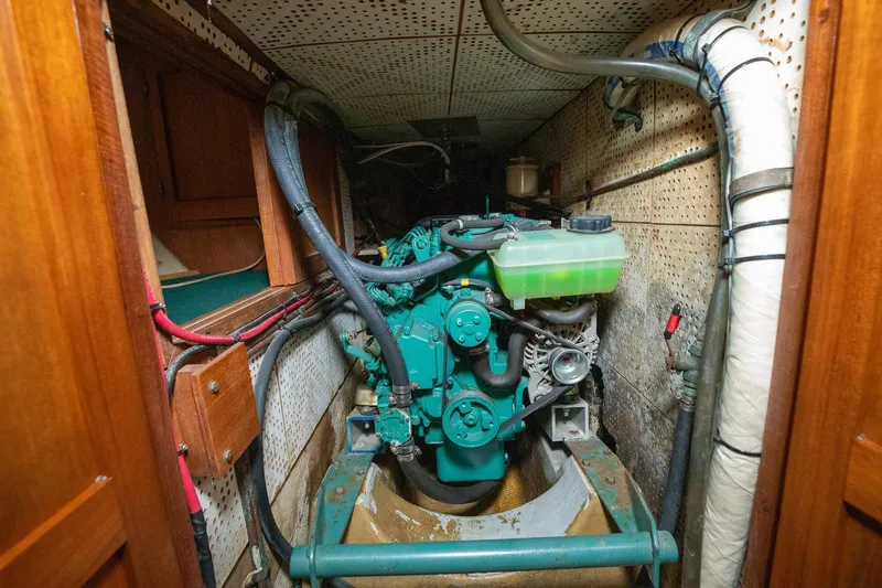 Slide: The Image of Engine room of a 1979 C&L Marine 36 boat, showcasing mechanical components and piping. - 46