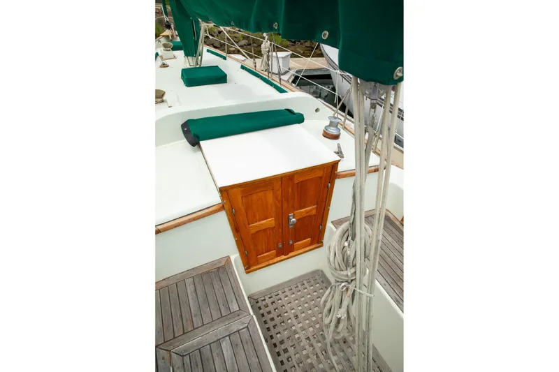 Slide: The Image of 1979 C&L Marine 36 sailboat deck with wooden hatch and green covers. - 9