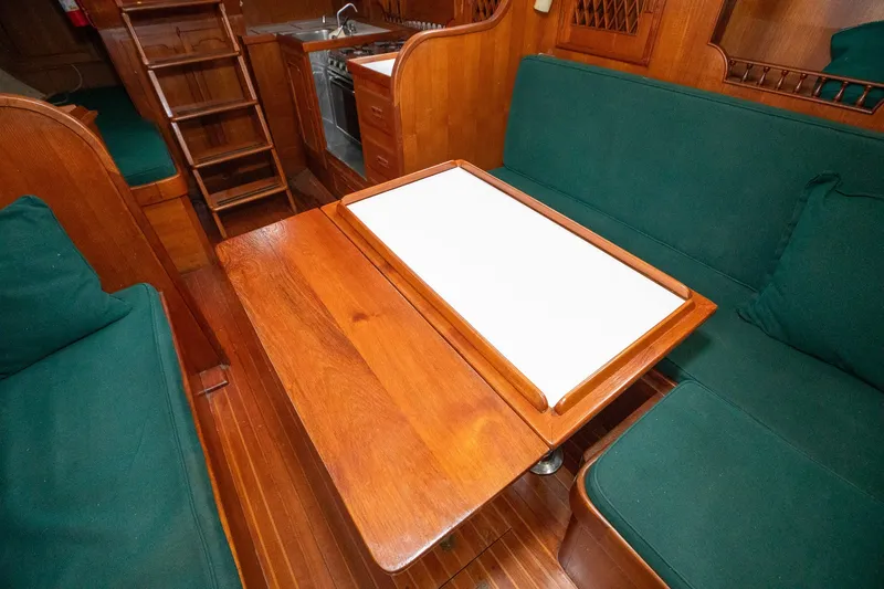 Slide: The Image of Interior of 1979 C&L Marine 36 yacht with wooden table and green seating. - 25