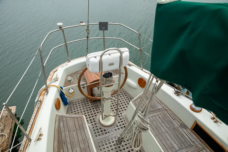 Slide: The Image of 1979 C&L Marine 36 sailboat cockpit with wooden deck and steering wheel. - 10