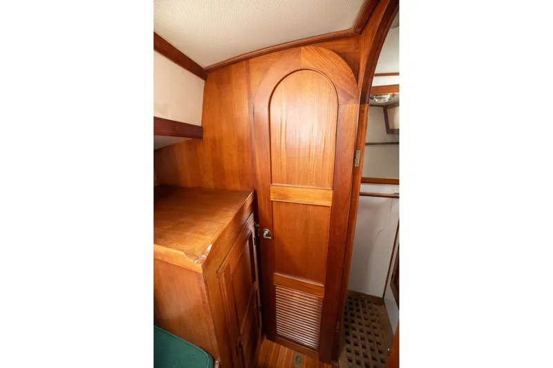 Slide: The Image of Wooden interior of 1979 C&L Marine 36 boat, featuring a closed door and cabinetry. - 34