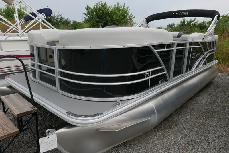 The Image of 2025 Sylvan Mirage 820 Cruise pontoon boat with sleek design on gravel surface. - 0