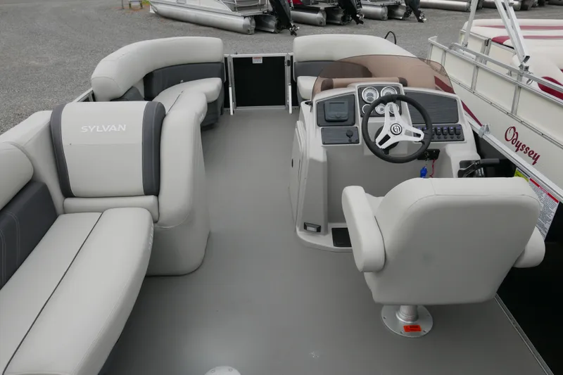 Slide: The Image of 2025 Sylvan Mirage 820 Cruise pontoon boat interior with steering console and seating. - 13