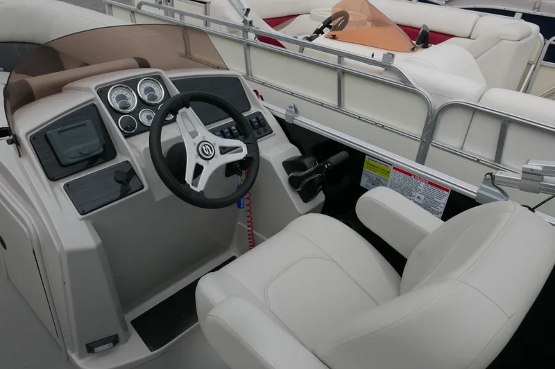 Slide: The Image of 2025 Sylvan Mirage 820 Cruise boat interior with steering wheel and dashboard controls. - 9