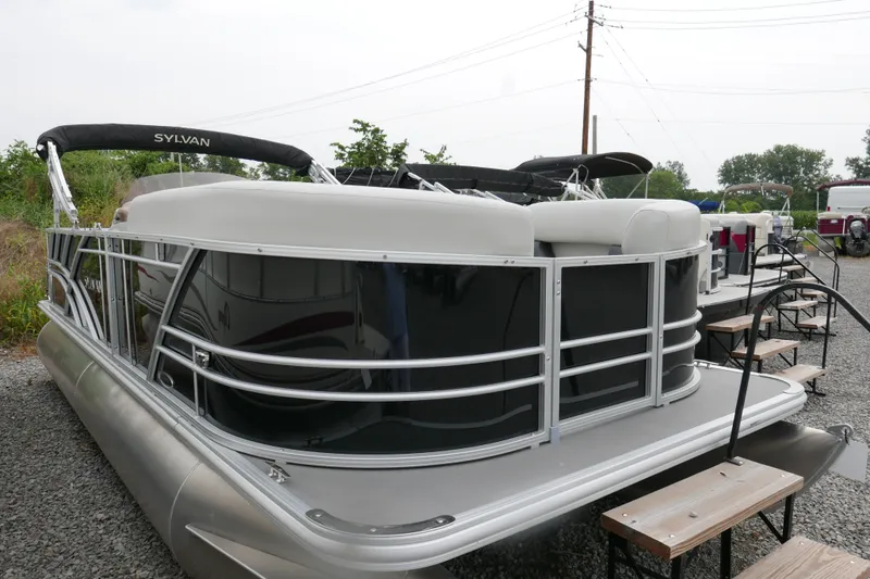 Slide: The Image of 2025 Sylvan Mirage 820 Cruise pontoon boat on gravel lot. - 1
