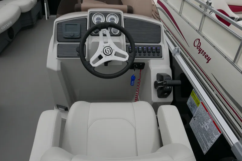 Slide: The Image of 2025 Sylvan Mirage 820 Cruise boat dashboard with steering wheel and controls. - 10