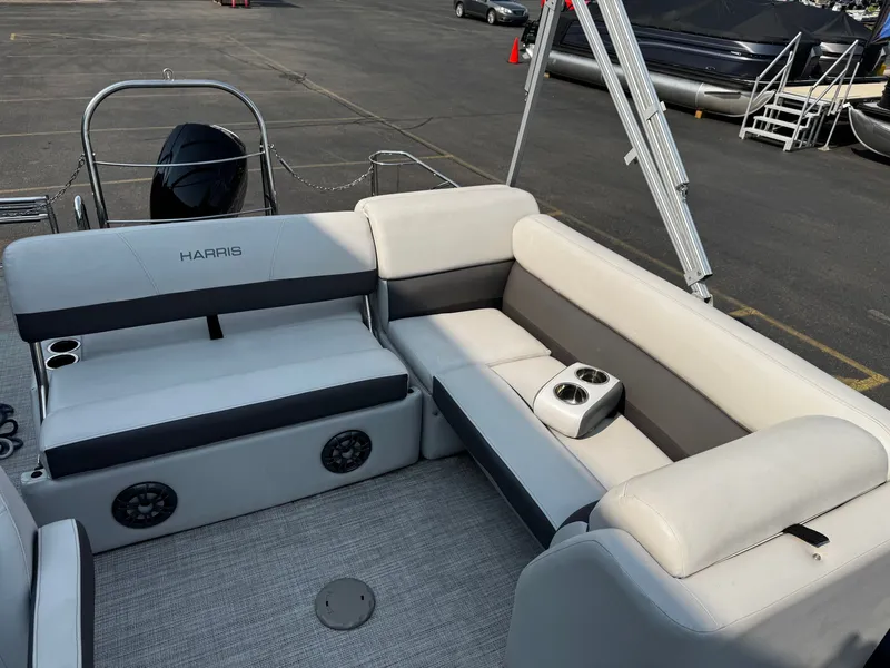 Slide: The Image of The image shows the seating area of a 2021 Harris Cruiser 230 pontoon boat with comfortable cushions. - 19
