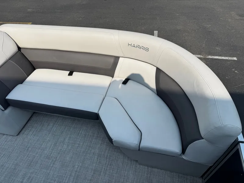 Slide: The Image of The image shows an elegant, upholstered seating area on a Harris Cruiser 230 boat. - 12