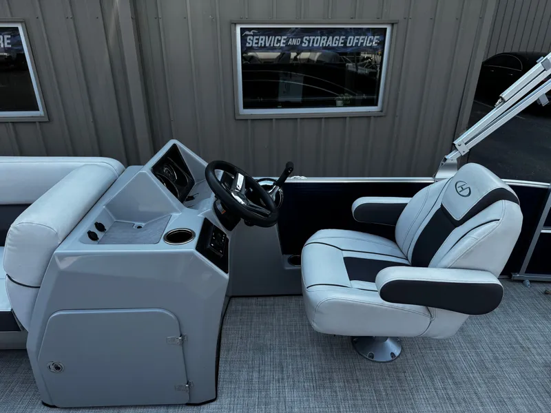 Slide: The Image of The image shows the helm of a 2021 Harris Cruiser 230 with a cushioned captain's chair. - 13