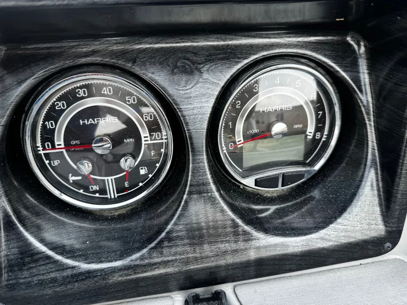 Slide: The Image of Close-up of two Harris instrument gauges on a boat panel. - 14