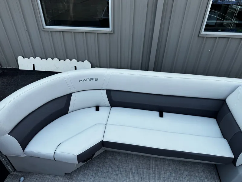 Slide: The Image of The image shows a white and gray seating area on a Harris Cruiser 230 boat. - 11