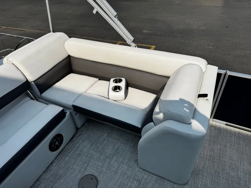 Slide: The Image of The image shows a bench seat on a 2021 Harris Cruiser 230 pontoon boat with cup holders. - 18