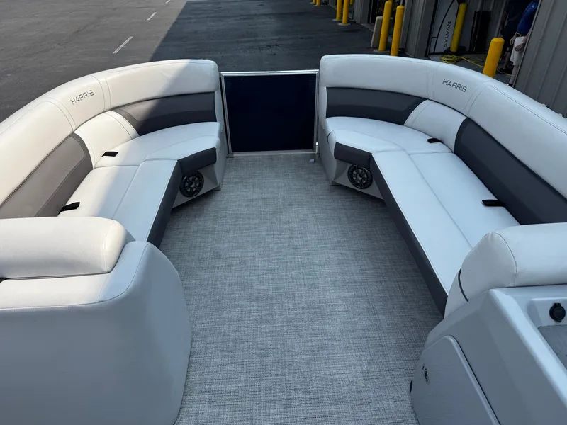 Slide: The Image of The image shows the interior of a 2021 Harris Cruiser 230 with white and gray seating. - 10