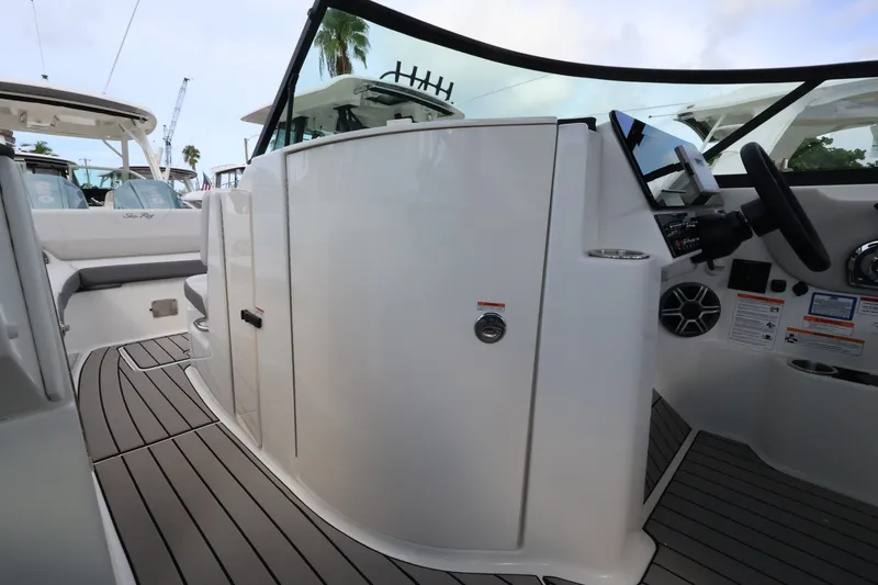 Slide: The Image of The image shows the cockpit of a 2027 Sea Ray SDX 270 Outboard with modern controls. - 21