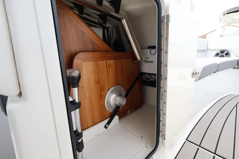 Slide: The Image of Storage compartment in Sea Ray SDX 270 Outboard with table and accessories. - 25