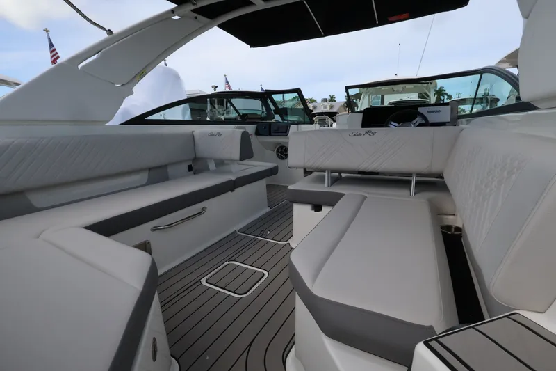 Slide: The Image of Interior of a Sea Ray SDX 270 Outboard with sleek white upholstery and gray flooring. - 9