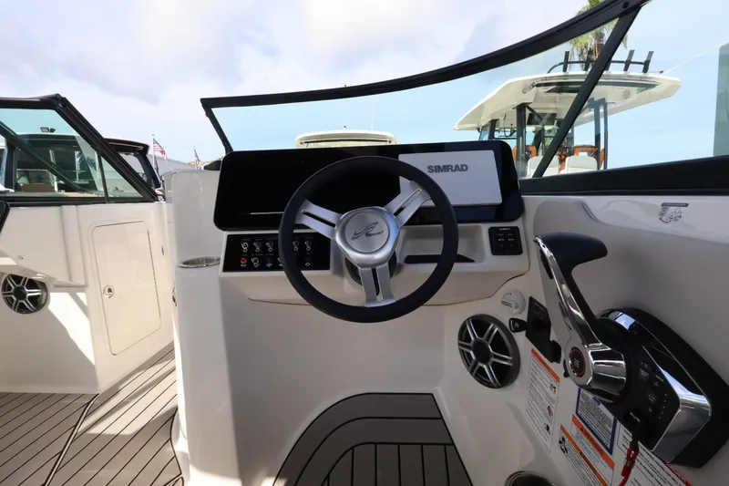 Slide: The Image of The image shows the helm of a Sea Ray SDX 270 Outboard with modern design and Simrad display. - 17