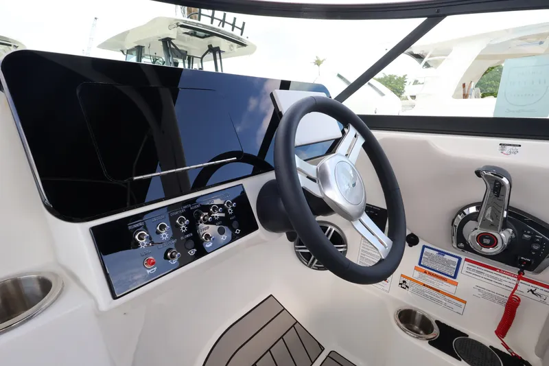 Slide: The Image of Helm of the Sea Ray SDX 270 Outboard with modern design and controls. - 16