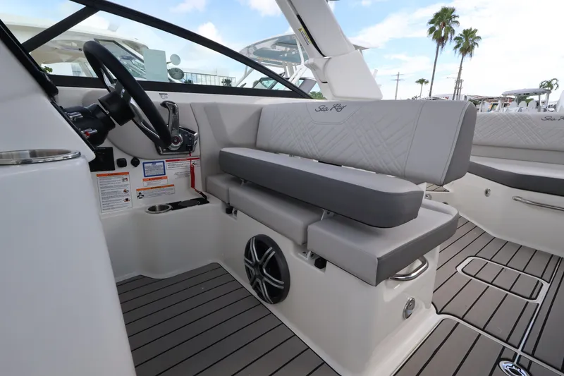 Slide: The Image of The image shows the cockpit of a Sea Ray SDX 270 Outboard with gray upholstery and modern controls. - 15