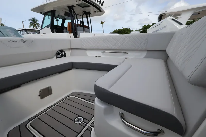 Slide: The Image of The 2027 Sea Ray SDX 270 Outboard features a sleek, cushioned seating area with gray accents. - 27
