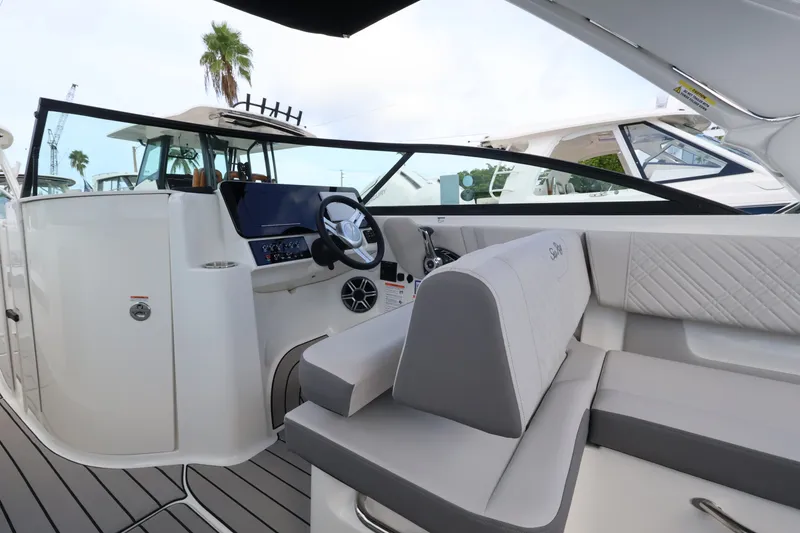 Slide: The Image of Interior of a Sea Ray SDX 270 Outboard with gray and white seating. - 14