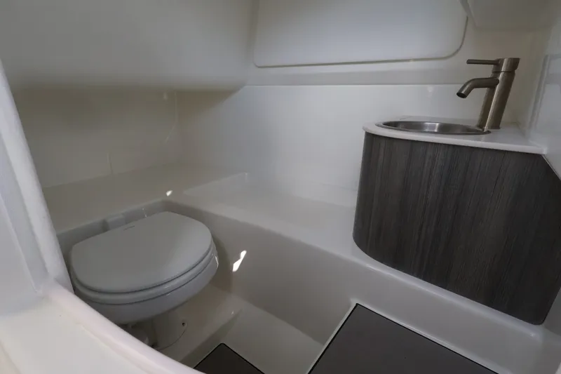 Slide: The Image of The image shows a modern boat bathroom with a toilet and sink. - 23