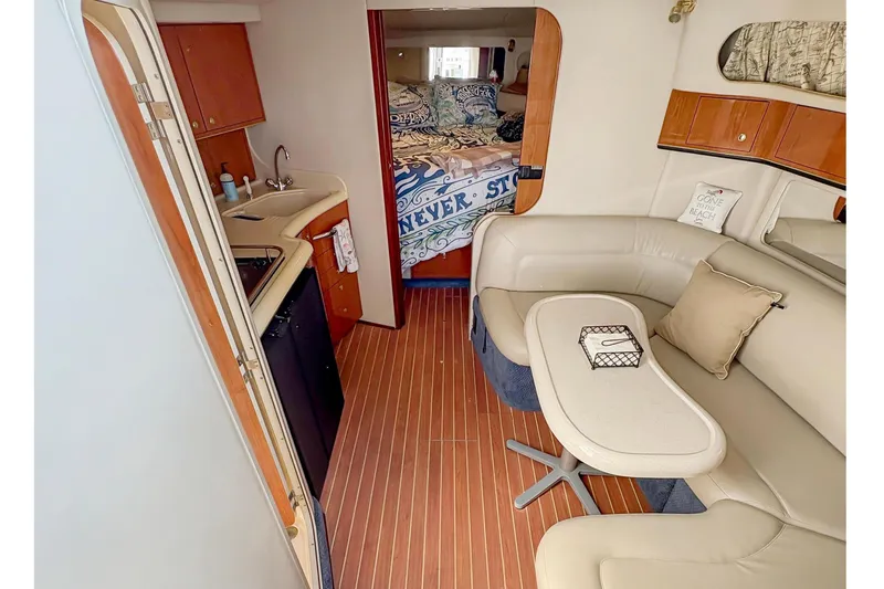 Slide: The Image of Interior of 1997 Sea Ray 370 Express Cruiser with cozy seating and kitchenette. - 21