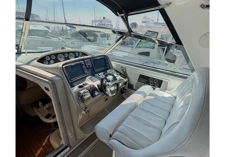 Slide: The Image of 1997 Sea Ray 370 Express Cruiser cockpit with steering wheel and navigation instruments. - 18