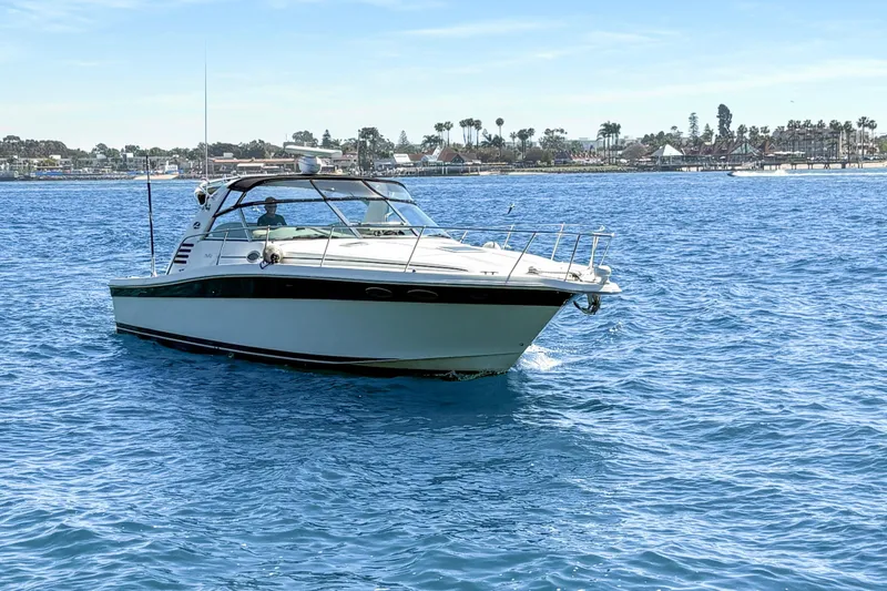 Slide: The Image of 1997 Sea Ray 370 Express Cruiser on calm blue waters under a clear sky. - 6