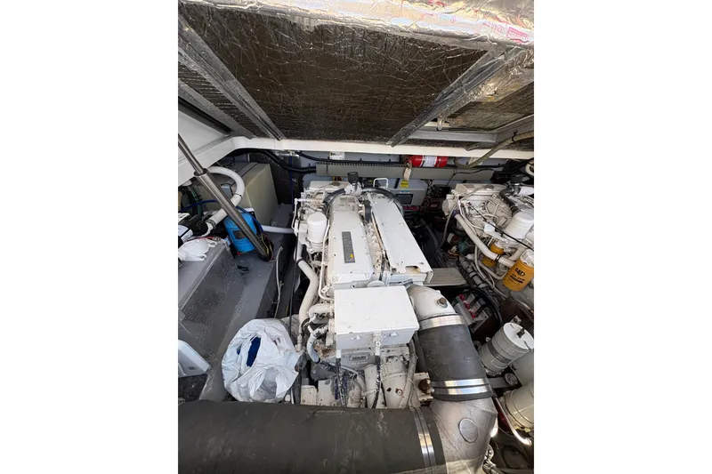 Slide: The Image of Engine room of a 1997 Sea Ray 370 Express Cruiser, showcasing mechanical components. - 28