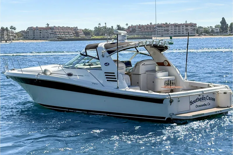 Slide: The Image of 1997 Sea Ray 370 Express Cruiser on calm blue water, sunny day. - 2