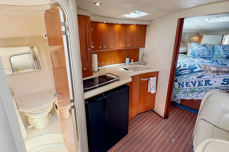 Slide: The Image of Interior of 1997 Sea Ray 370 Express Cruiser with kitchenette, bathroom, and cozy sleeping area. - 20