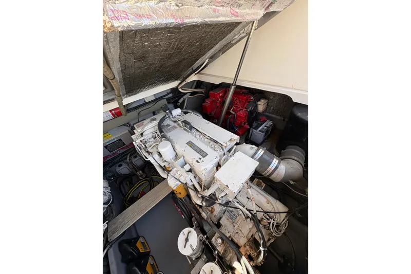 Slide: The Image of Engine compartment of a 1997 Sea Ray 370 Express Cruiser, showcasing mechanical components. - 27