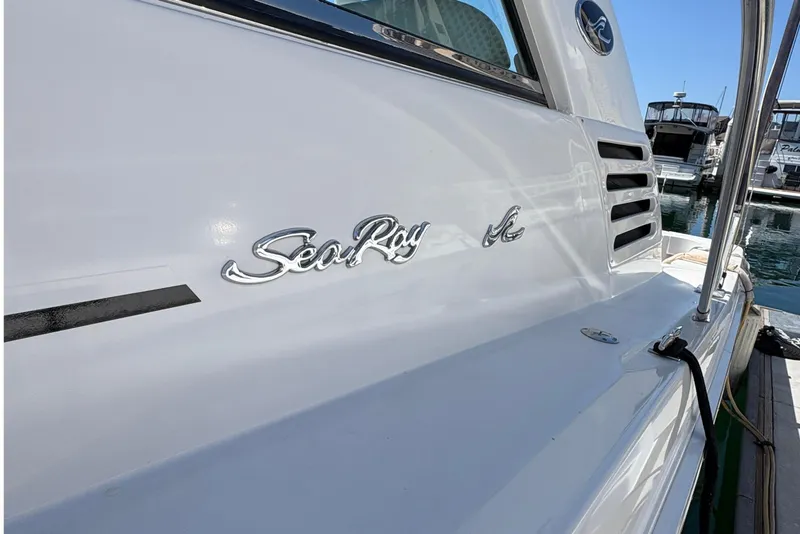 Slide: The Image of 1997 Sea Ray 370 Express Cruiser docked, showcasing sleek white exterior and logo. - 26