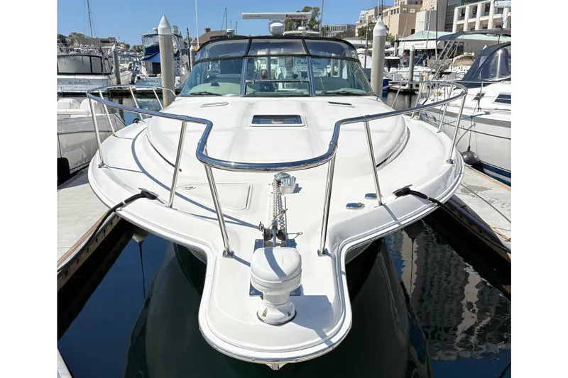 Slide: The Image of 1997 Sea Ray 370 Express Cruiser docked at marina, front view. - 12
