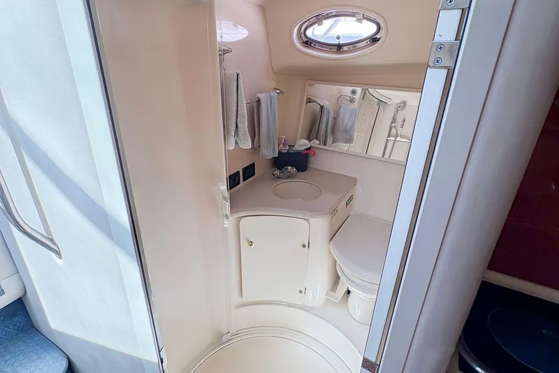 Slide: The Image of 1997 Sea Ray 370 Express Cruiser bathroom with sink, toilet, and mirror. - 23