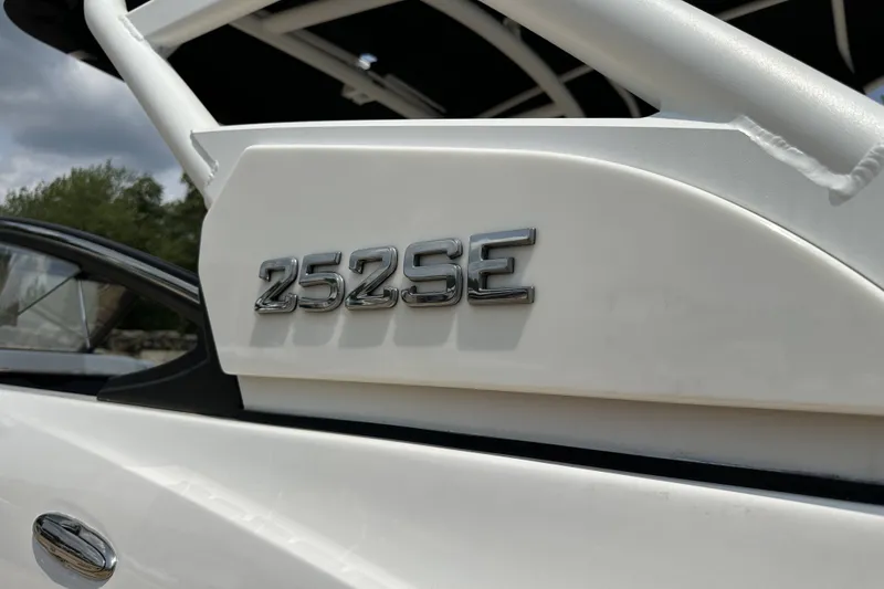 Slide: The Image of 2023 Yamaha Boats 252SE emblem on sleek white exterior. - 14
