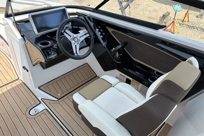Slide: The Image of 2023 Yamaha Boats 252SE cockpit with modern steering wheel and digital display. - 8