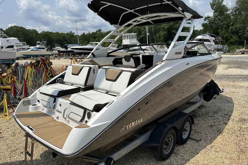Slide: The Image of 2023 Yamaha Boats 252SE on trailer, sleek design, outdoor setting. - 2