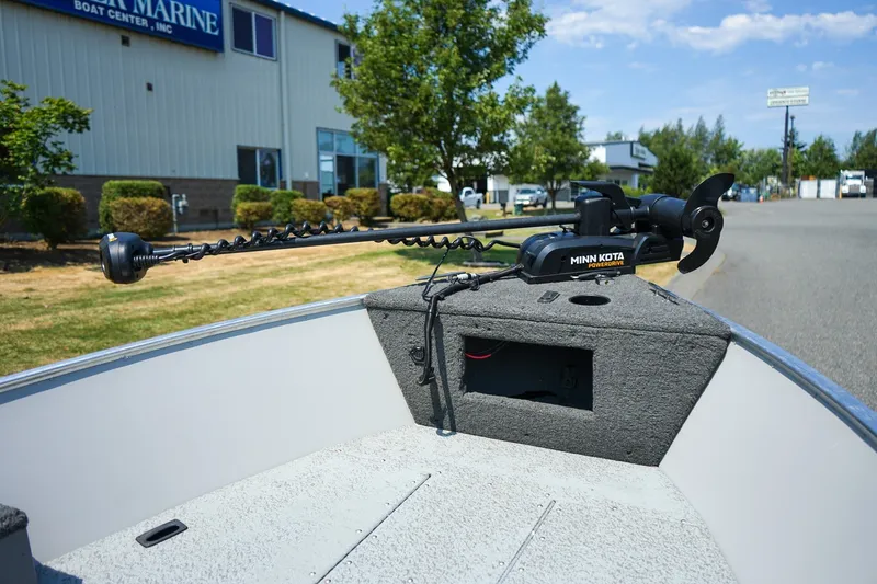 Slide: The Image of 2015 Lund 1400 Fury SS boat with Minn Kota PowerDrive motor at a marine center. - 13