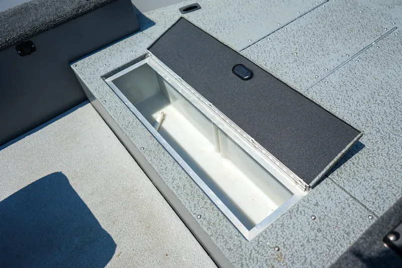 Slide: The Image of 2015 Lund 1400 Fury SS boat storage compartment with open lid, showcasing interior space. - 10
