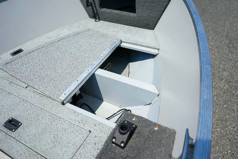 Slide: The Image of 2015 Lund 1400 Fury SS boat interior with open storage compartment. - 11