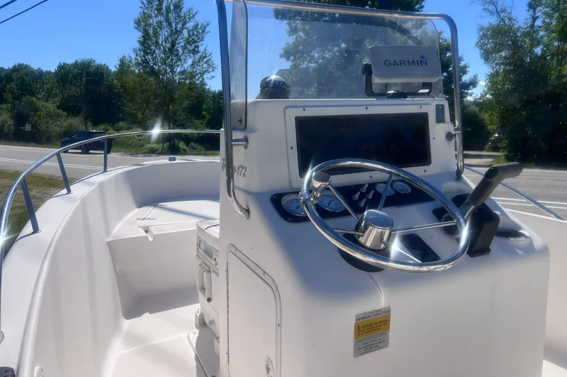 Slide: The Image of 2004 Sea Hunt Triton 177 boat dashboard with Garmin navigation system and steering wheel. - 6