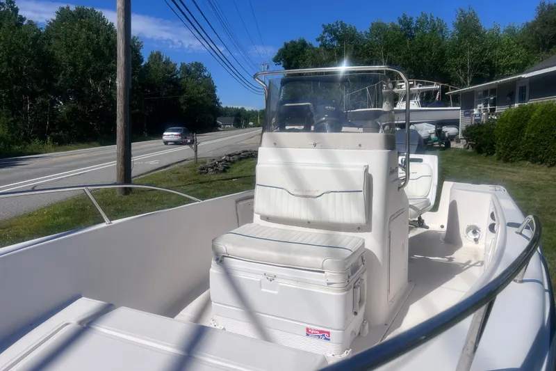 Slide: The Image of 2004 Sea Hunt Triton 177 boat parked roadside, featuring center console and seating. - 4