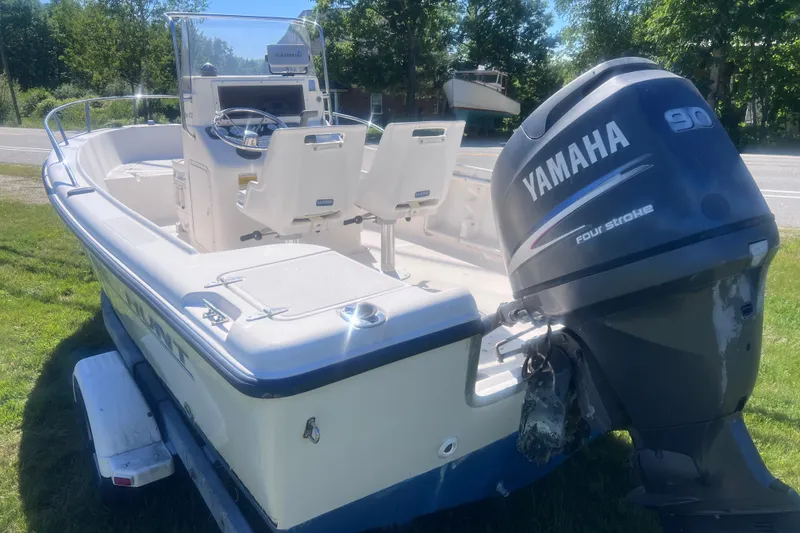 Slide: The Image of 2004 Sea Hunt Triton 177 boat with Yamaha 90 four-stroke engine on grassy area. - 5